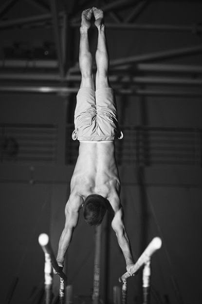Gymnast holding a handstand on parallel bars