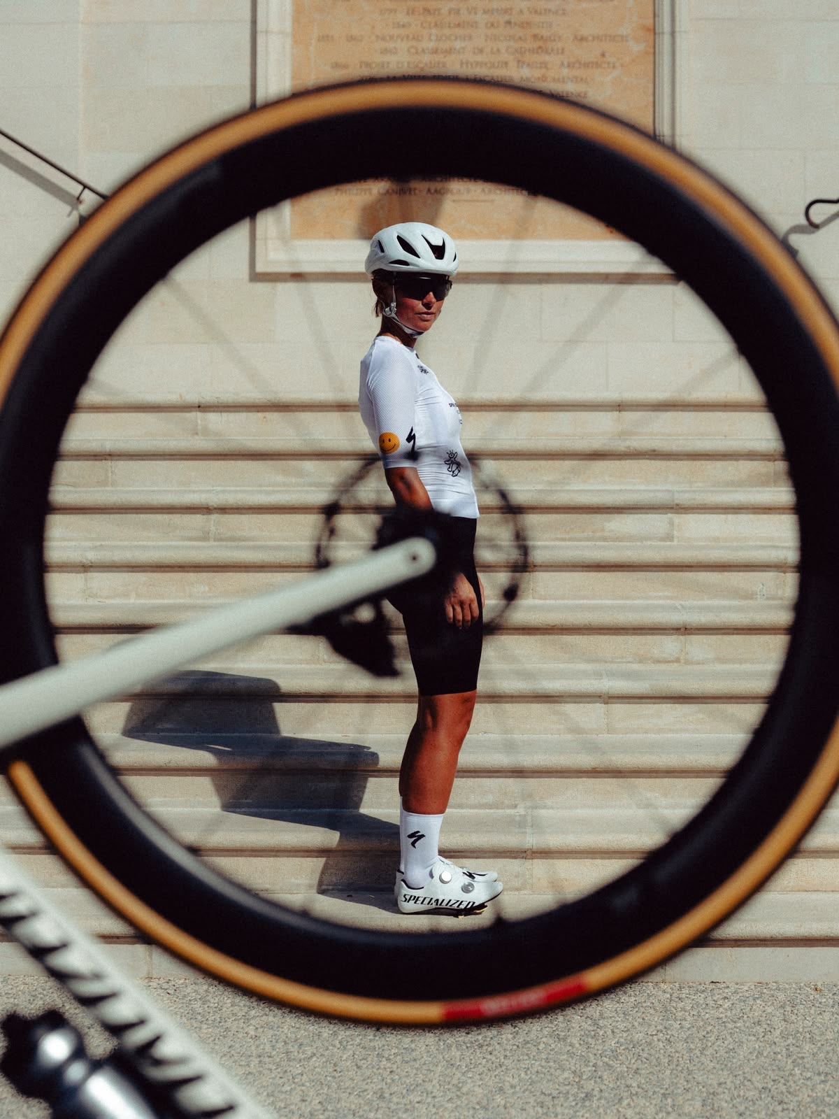 Cyclist framed by a bicycle wheel